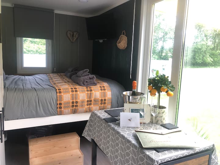 Comfy double bed with storage underneath. 
Smart tv on the wall at the foot of the bed, wall mounted so can be adjusted for viewing anywhere in the hut. 