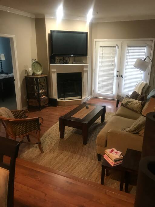 View from Entry: Dining Room Opens Into Sunken Living Room with Fireplace and Covered Balcony