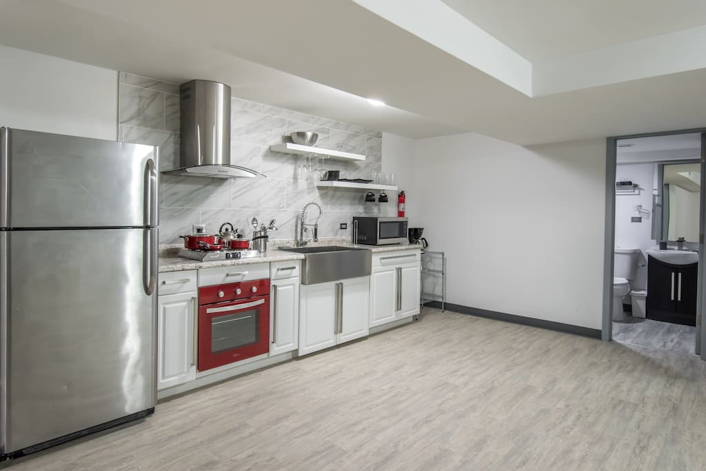 Newly remodeled kitchen with stainless steel appliances, stocked with all supplies needed for a home-cooked meal