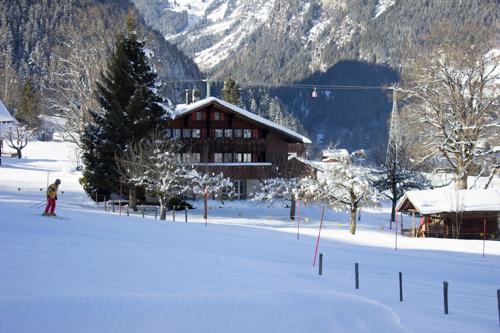 Chalet from the road with skier