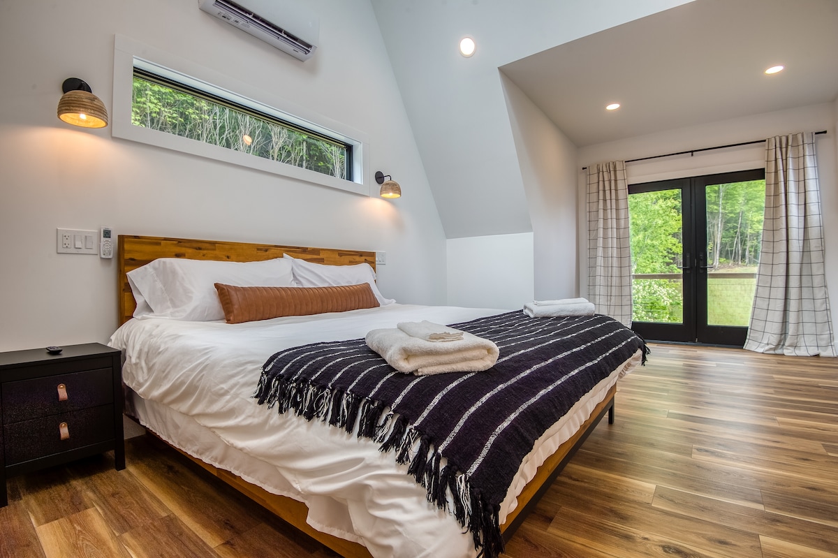 2nd floor primary bedroom with king bed and private balcony 