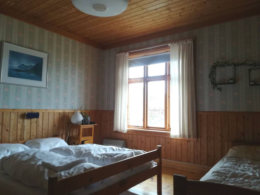 The room is furnished with a double and a single bed