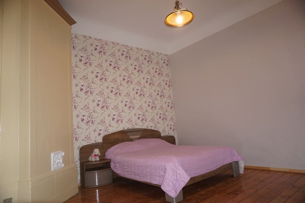 Queen bedroom with large wardrobe and renovated wooden floor