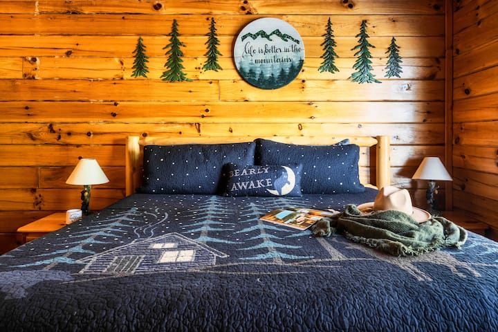 King en-suite bedroom with cozy mattress and pillow assortment.