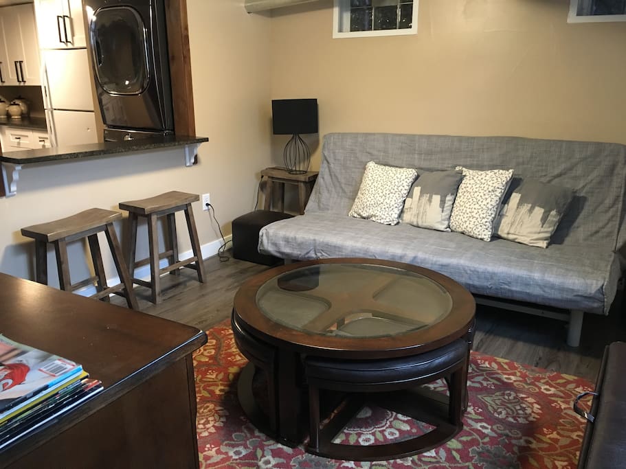 Cozy family room with queen bed, coffee table, bar, window and TV with Roku