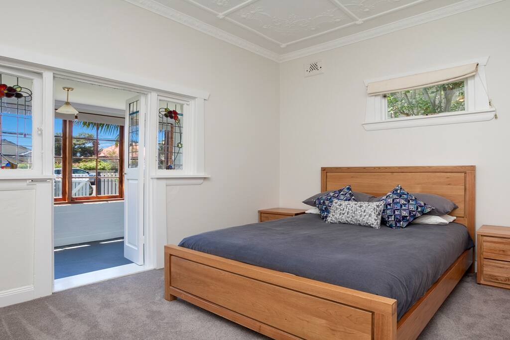 Large master bedroom with solid timber furniture and attached sunroom which is set up as a nursery.