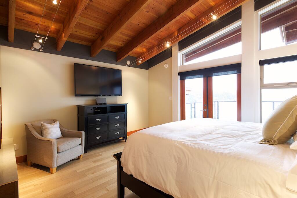 Master bedroom with flat screen, king bed, gas fireplace, huge soaker tub and ensuite