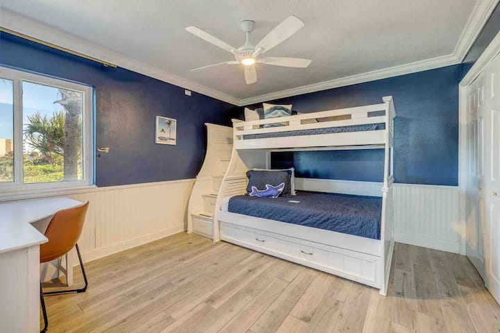 Bunk room with a full sized bottom bunk, twin top bunk, and a twin pull out trundle bed.