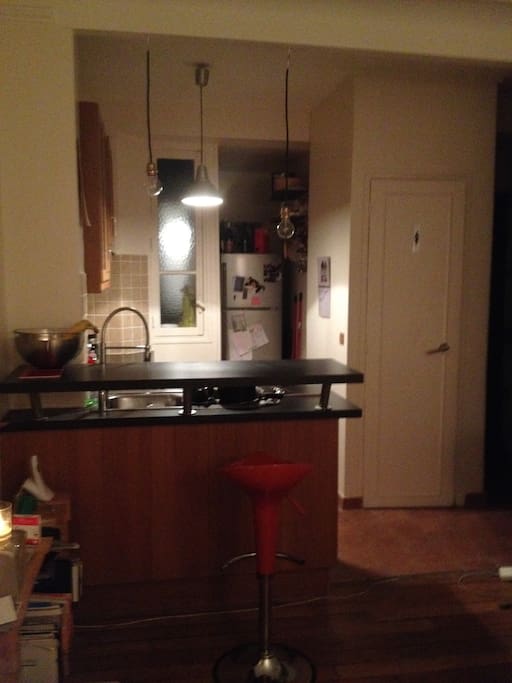 At the opposite of the living-room a fitted kitchen and a bar :-)