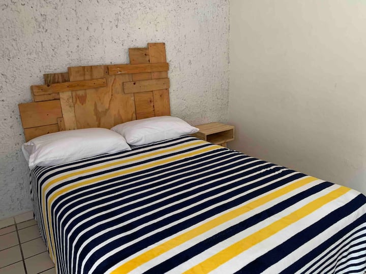 Second bedroom with double bed, bureau, equipment and large closet with ceiling fan 