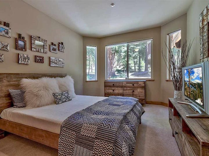 Lower level bedroom with a queen bed and a flat screen smart TV.