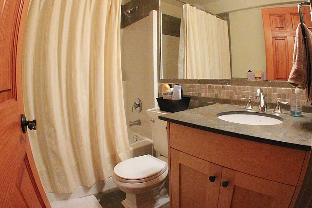 Bathroom with blow dryer and toiletries.