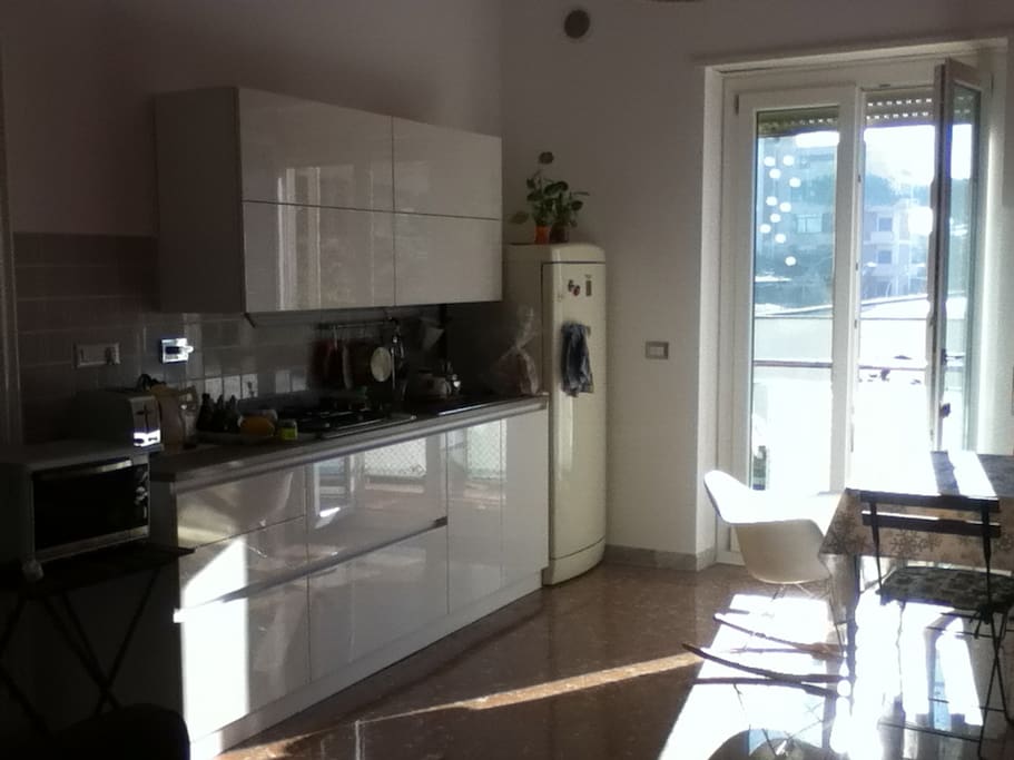 Sunny kitchen/open living room with cozy balcony