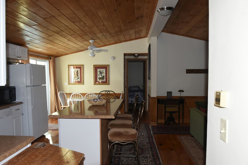 Open concept living room and kitchen, breakfast bar beautiful wood floors and ceilings