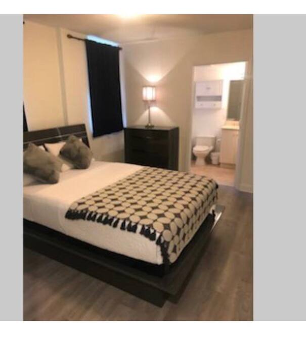 Master bedroom with queen size bed and bathroom