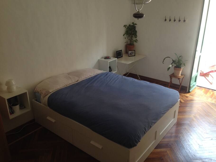 Double bed in bedroom with balcony