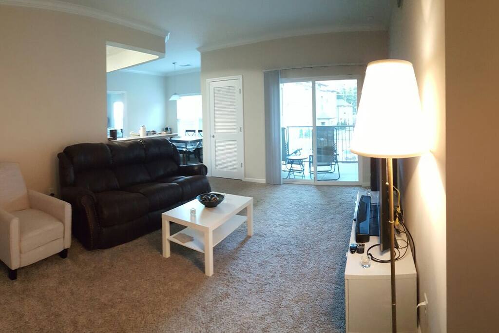 Balcony on the right and view of the dining area with kitchen on the left.