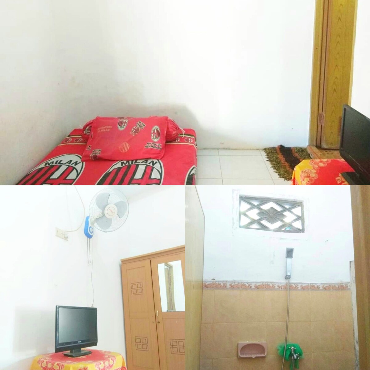 A simple room is depicted with a cozy bed dressed in red linens. A flat-screen TV is mounted on the wall, and a ceiling fan is visible providing ventilation. The ensuite bathroom includes a shower and a window, enhancing the space's functionality.