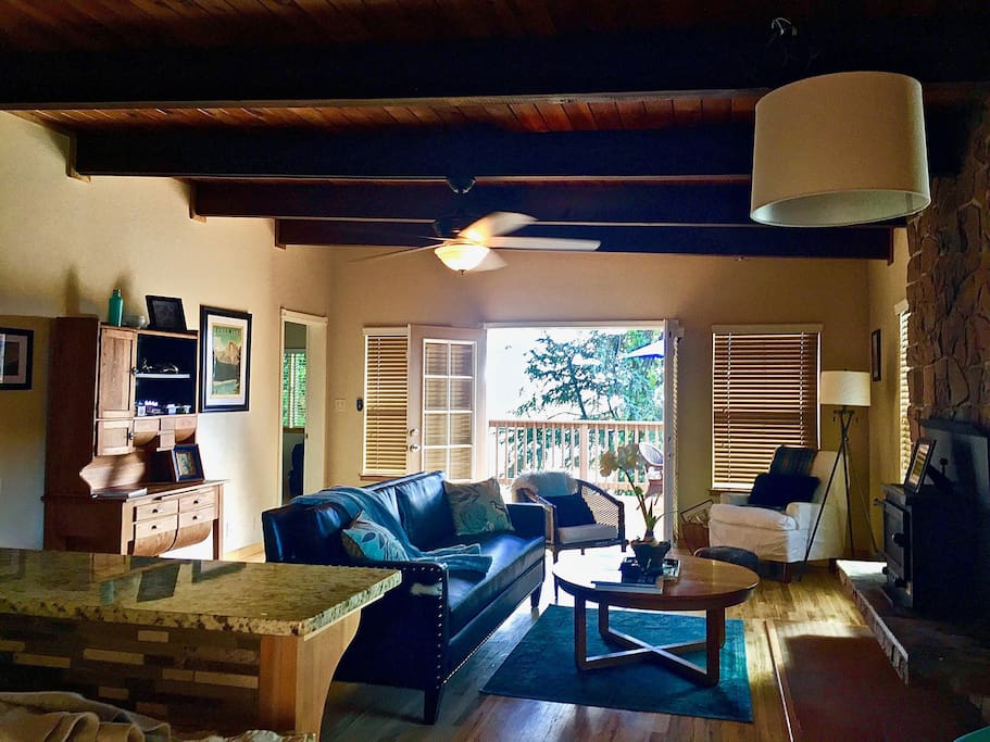 Cozy living room with French doors to the pool, town lights & views of the lovely trees.
