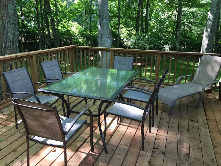 Shady deck off kitchen with natural gas barbecue