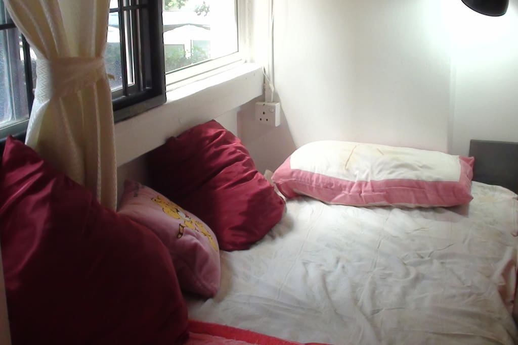 Bed with reading lamp and near window