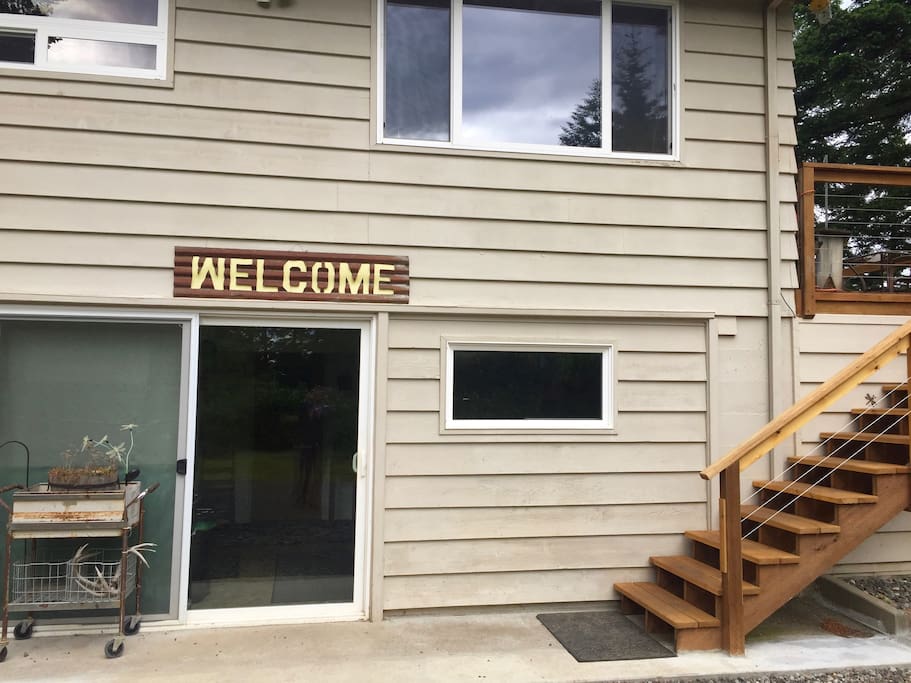 Guests enter under the welcome sign into a shared common area and then into their room.