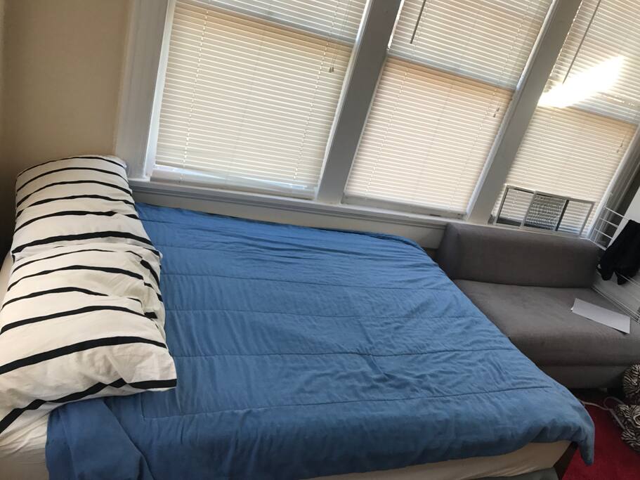 Full size bed with new mattress. Bedroom windows open to a perfect view of the neighborhood.