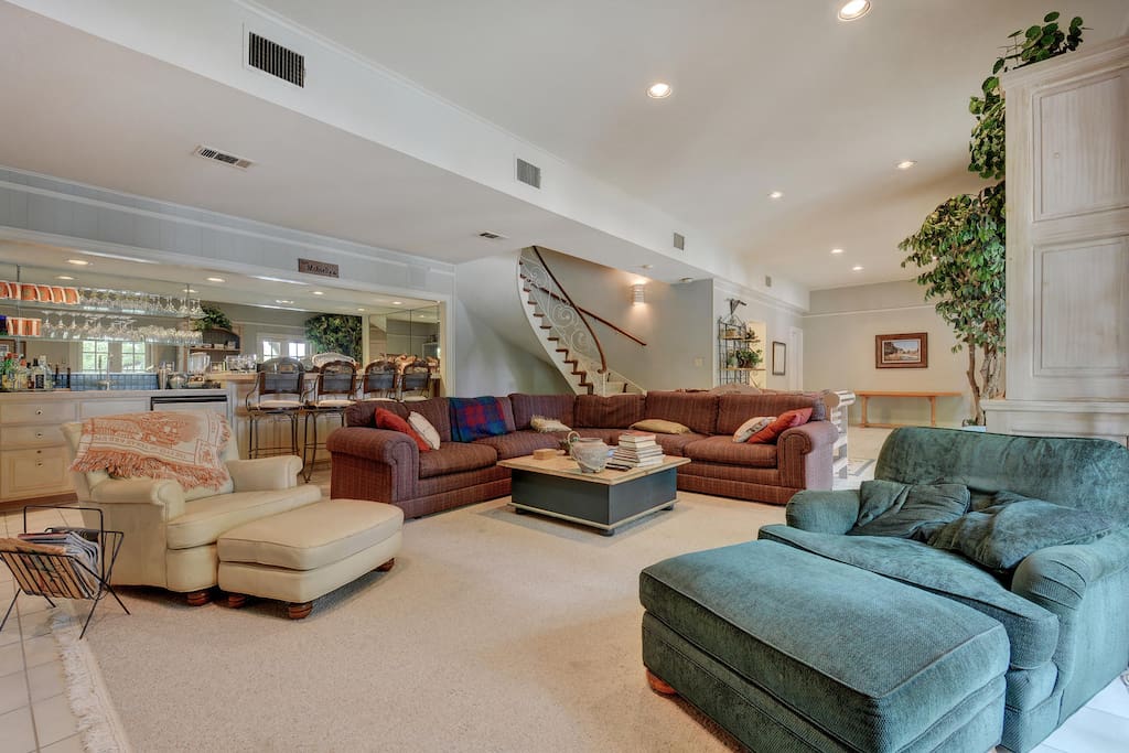 Overstuffed couches and chairs for cozy seating. The bar behind provides the refreshments!