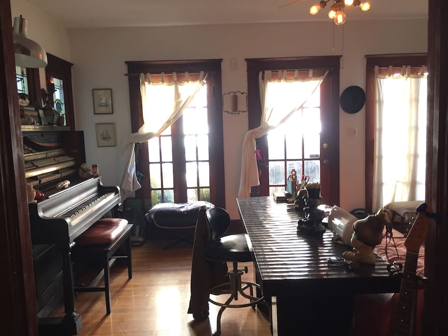 Living room with 100 yr old piano, record player and computer desk