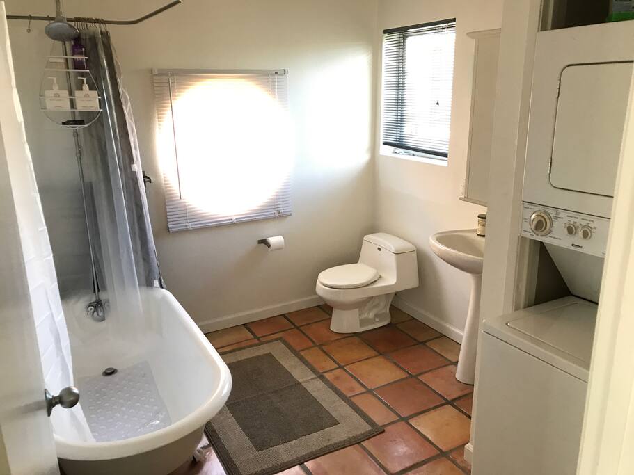 Light and airy bathroom, complete with washer & dryer.