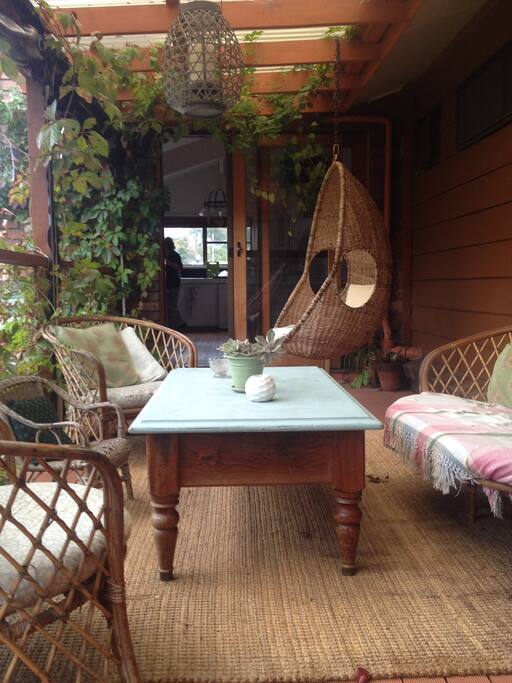 Relax on the back balcony in the afternoon sunshine overlooking the gardens