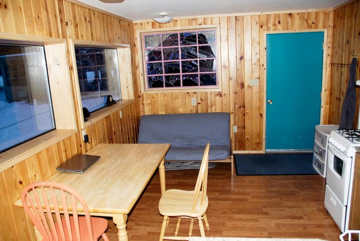 Here is your 4 Corners Glacier Bay Cottage main living room, with double bed sofa/bed and table.