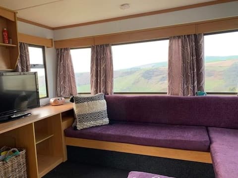 Cozy satic caravan with a log burner for couples.
