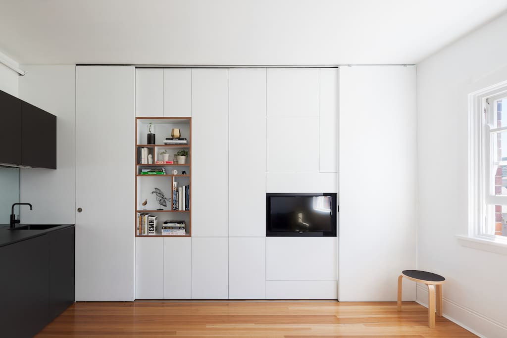 the apartment has a joinery wall which incorporates everything you'll need for your stay - A bedroom, bathroom, tv, books and storage.