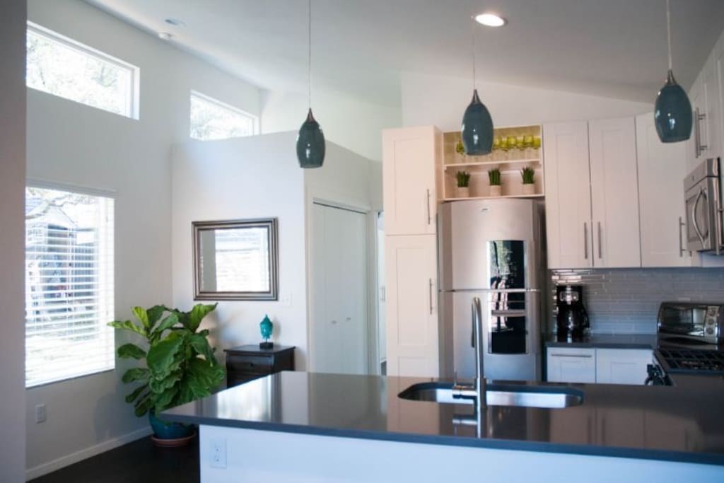 Bright, open layout with full kitchen, living space, bedroom and full bath. Additional workspace at bar, if needed.