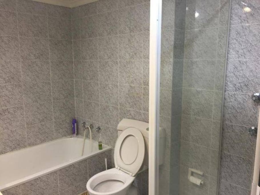 Bathroom with bath and shower