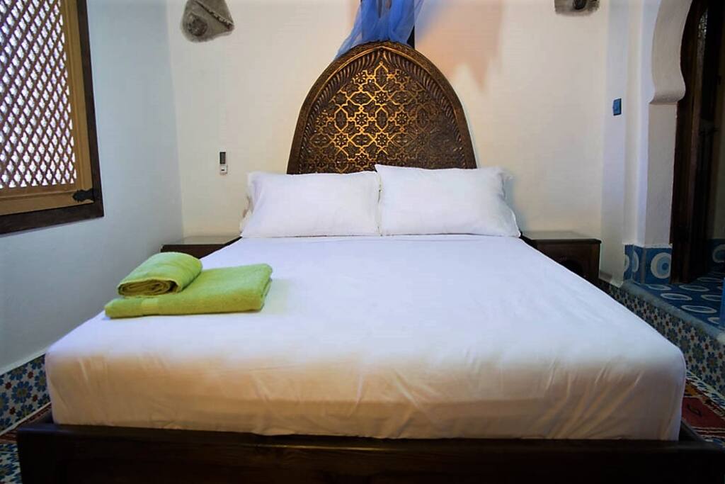 Queen size Master bedroom with en suite bathroom and storage, and plenty of sunlight.