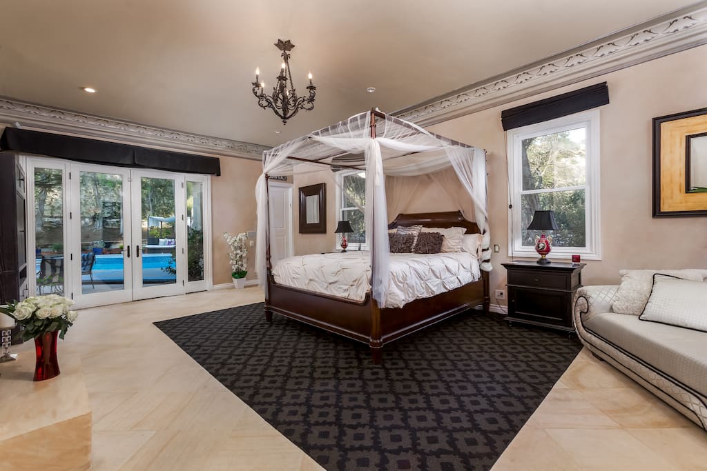 The master suite also features a chaise lounge sitting area as well as seating by the pool directly outside of the French doors.