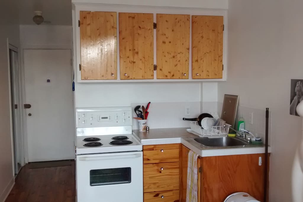 cuisine equipée et avec vaisselle, dans le couloir à gauche salle de bain avec bain toilettes et miroir.