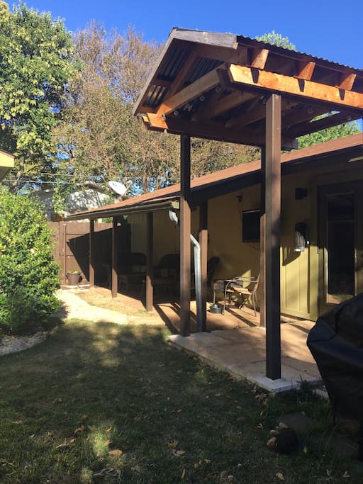 Back porch sitting area with outdoor TV