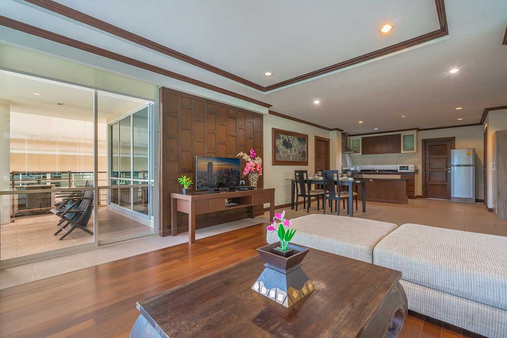 A broad view of the lounge, balcony, dining and kitchen areas