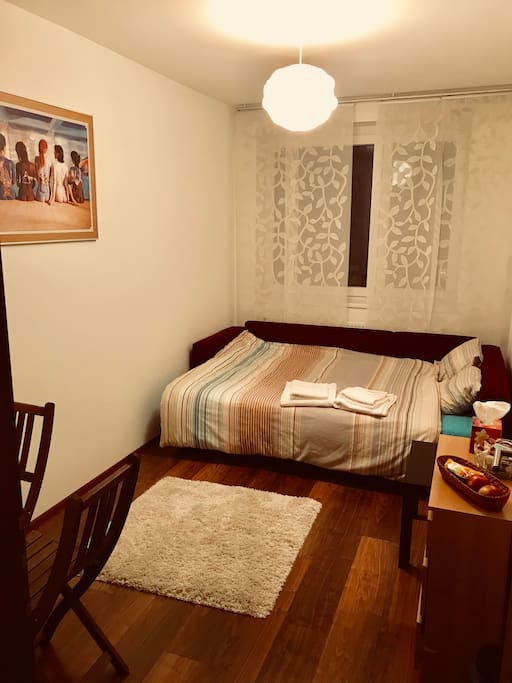 Clean and cozy bedroom with double bed, 3 drawer unit, table with 2 chairs and a closet. Also a complementary basket of chocolate and candies :)