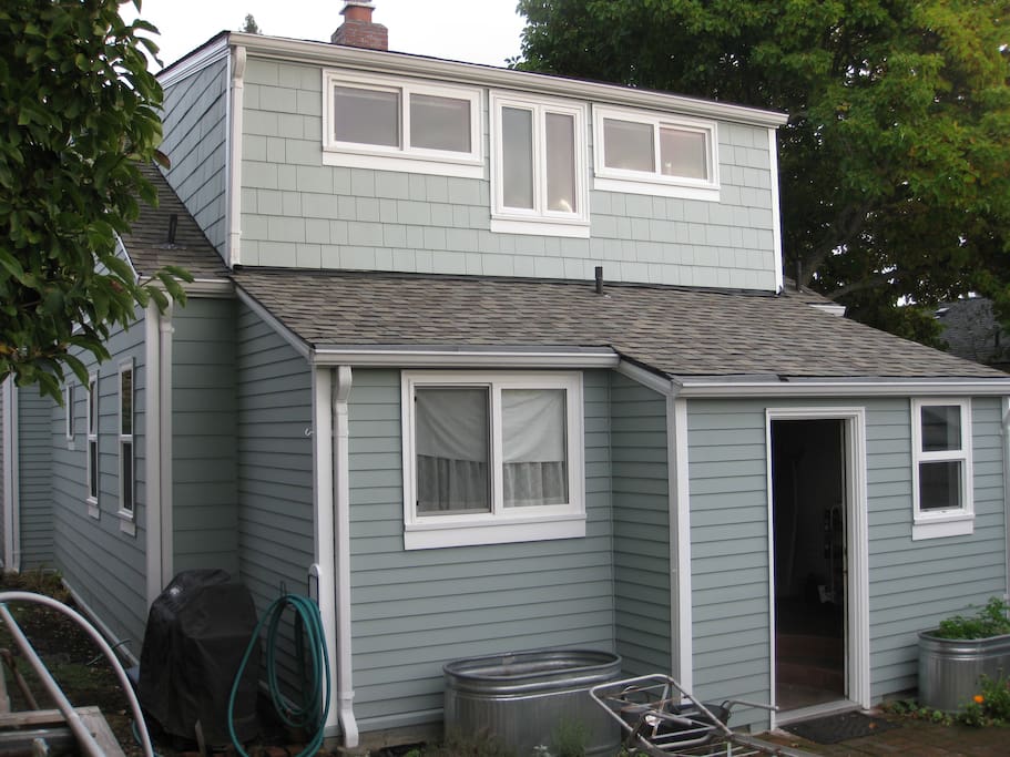 Back of house leads out to small patio. Second-story office/bedroom with western views of Olympic Mountains.
