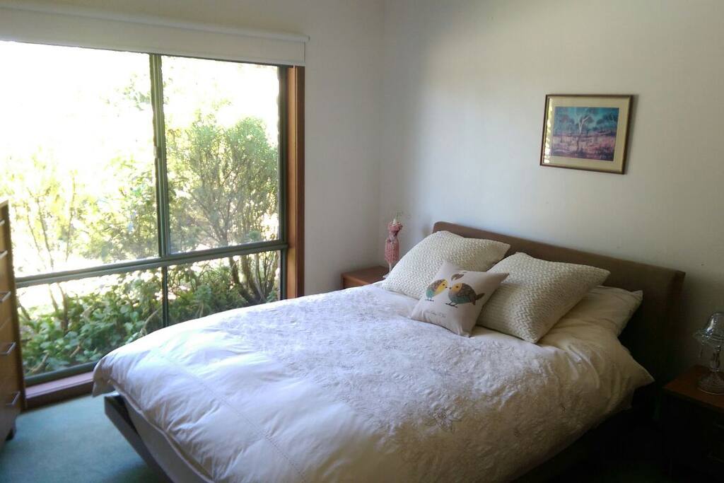 Queen size bed facing south side of the property