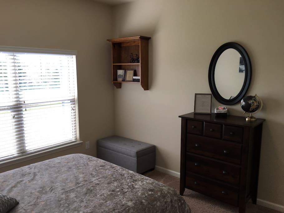 Backyard View, Bedroom has Closet w/ hangers, Dresser & Nightstand.