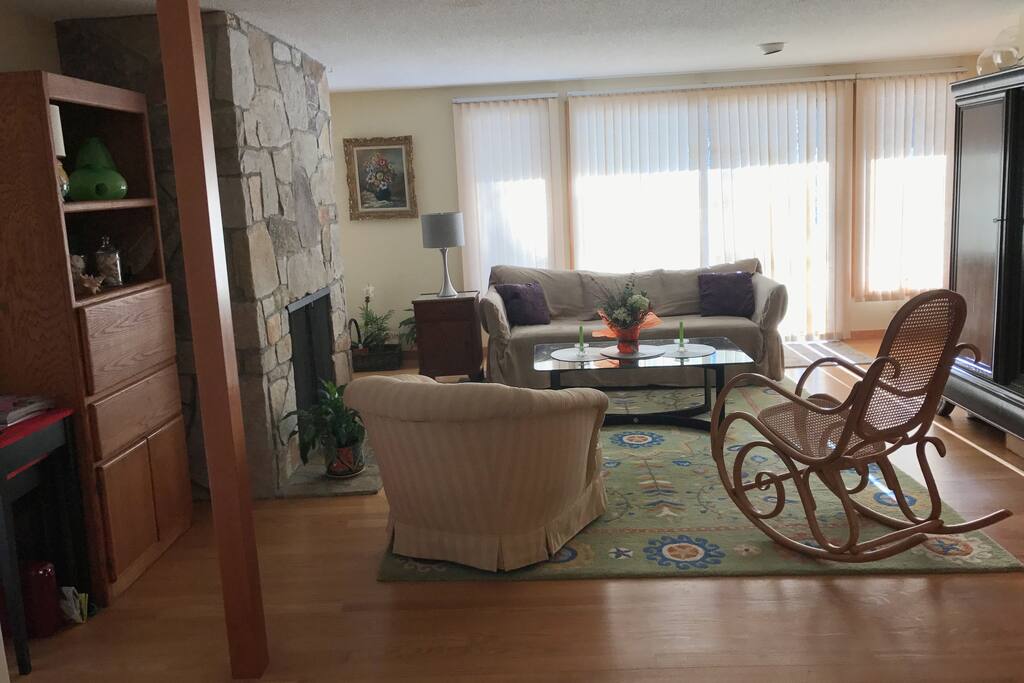 Living room with fireplace and glass doors to deck and patio