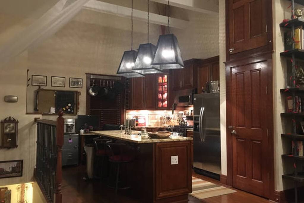 High ceilings throughout make the space feel even bigger! You can see the entrance/stairs to the left.
