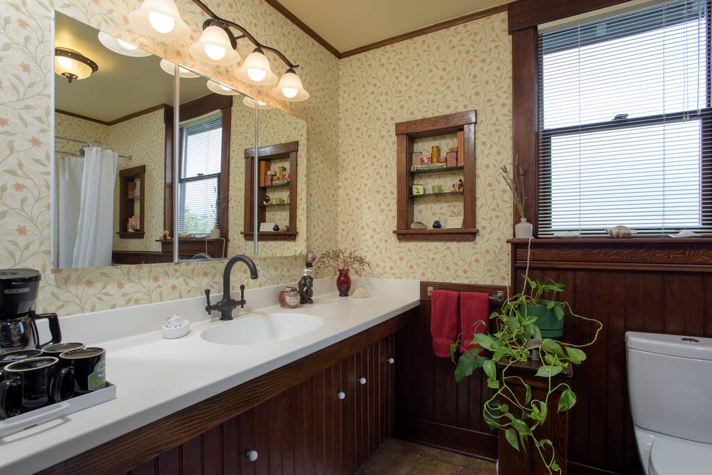 Guest bathroom with large bar sized sink and faucet. Coffee, tea, and accessories provided.