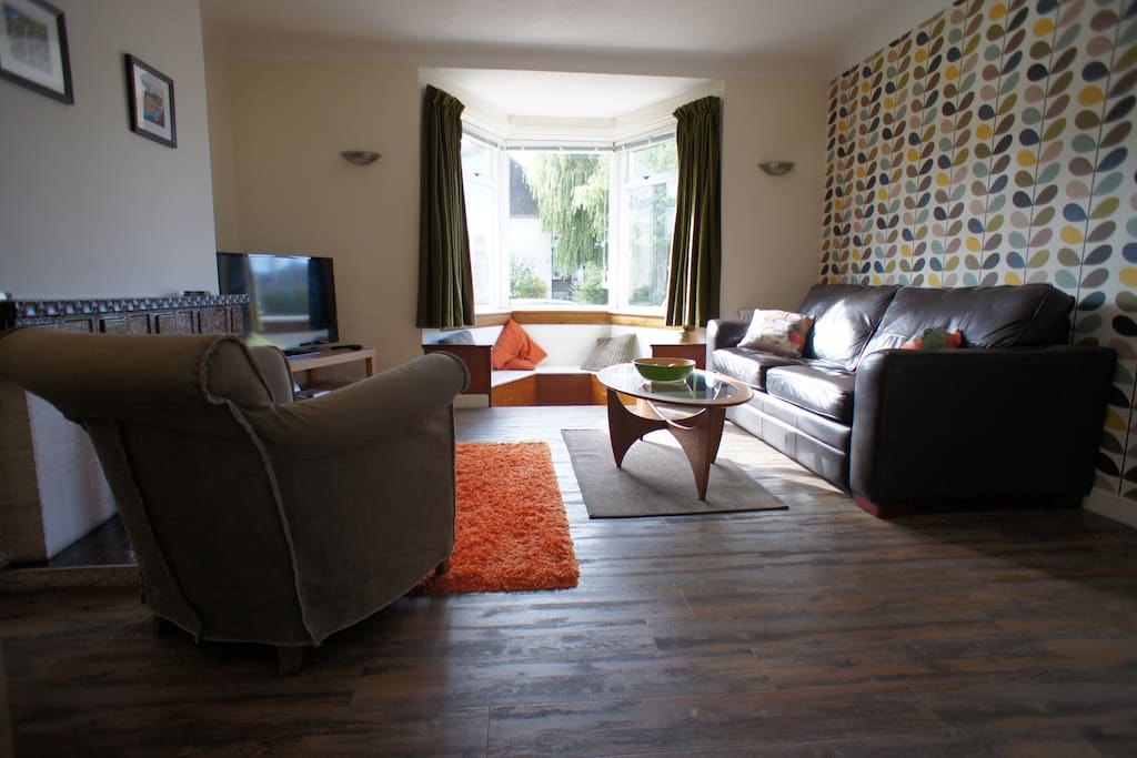 Large bright and spacious living room with dining table for six and free unlimited WI-FI