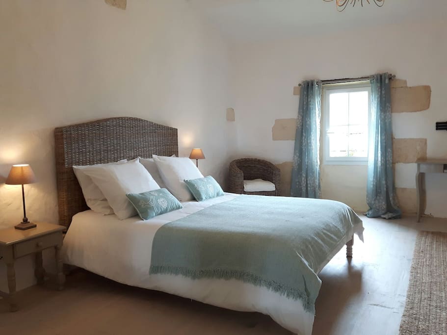 The bedroom has high ceilings
